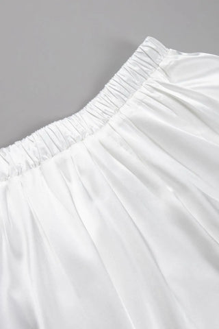 Close-up of back elastic waistband on white satin midi skirt – Voguelle