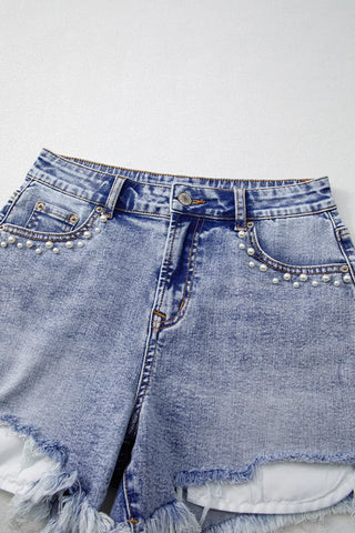 Close-up of raw hem edge on pearl studded denim shorts – Voguelle