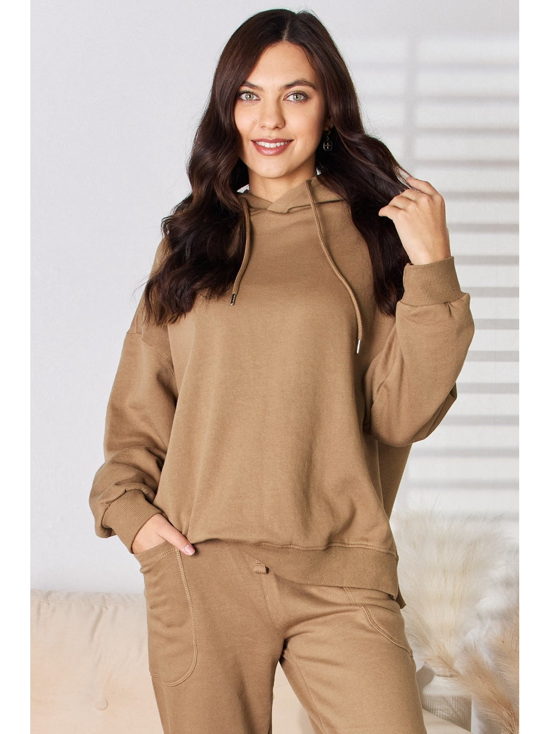 Casual brown hooded sweatshirt with ribbed cuffs shown on model – Voguelle