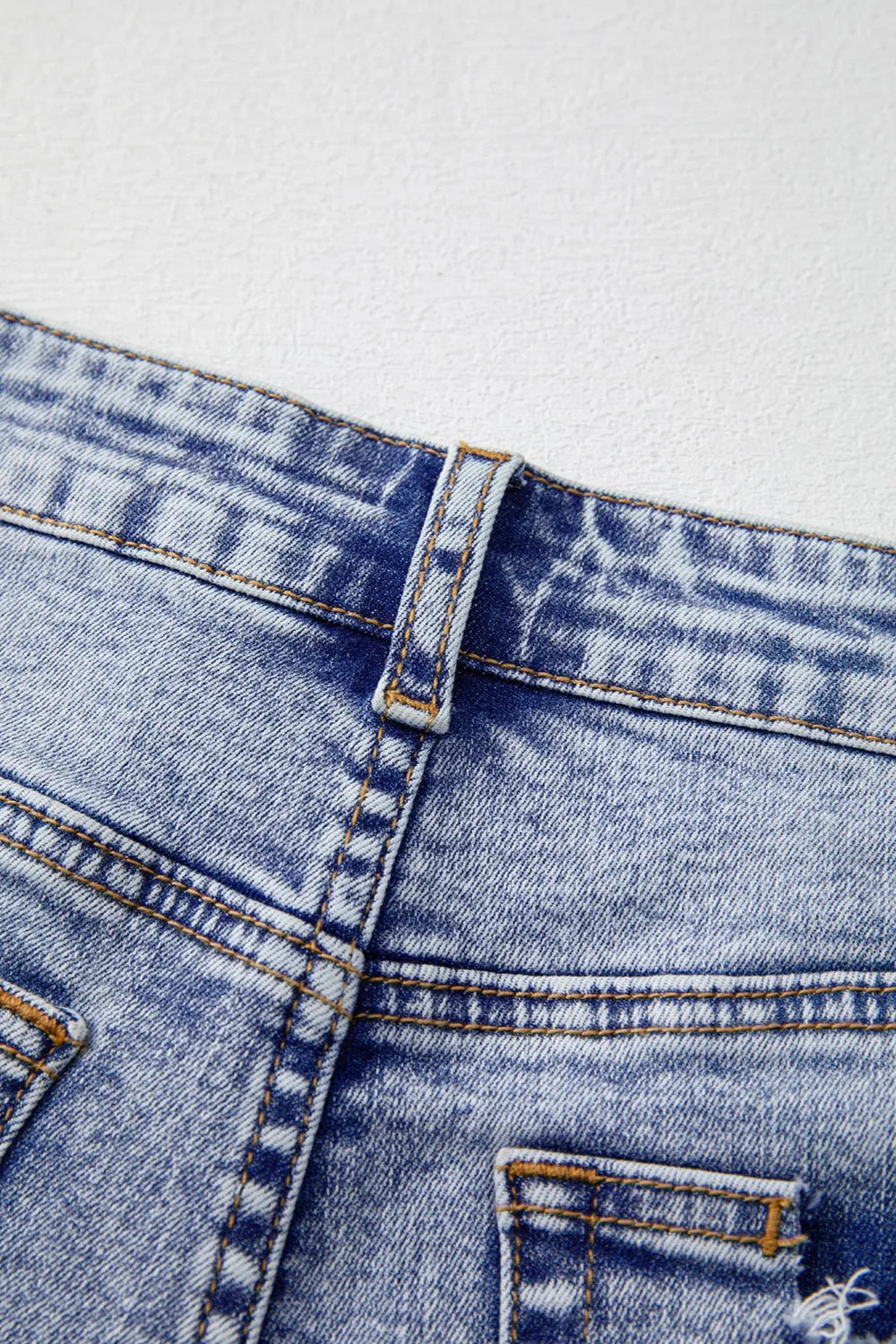Close-up of pearl embellishment on denim shorts – Voguelle
