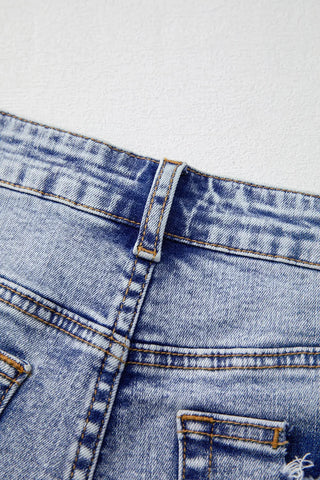 Close-up of pearl embellishment on denim shorts – Voguelle