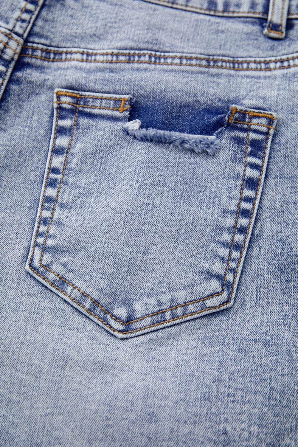 Close-up waistband detail of pearl studded denim shorts – Voguelle