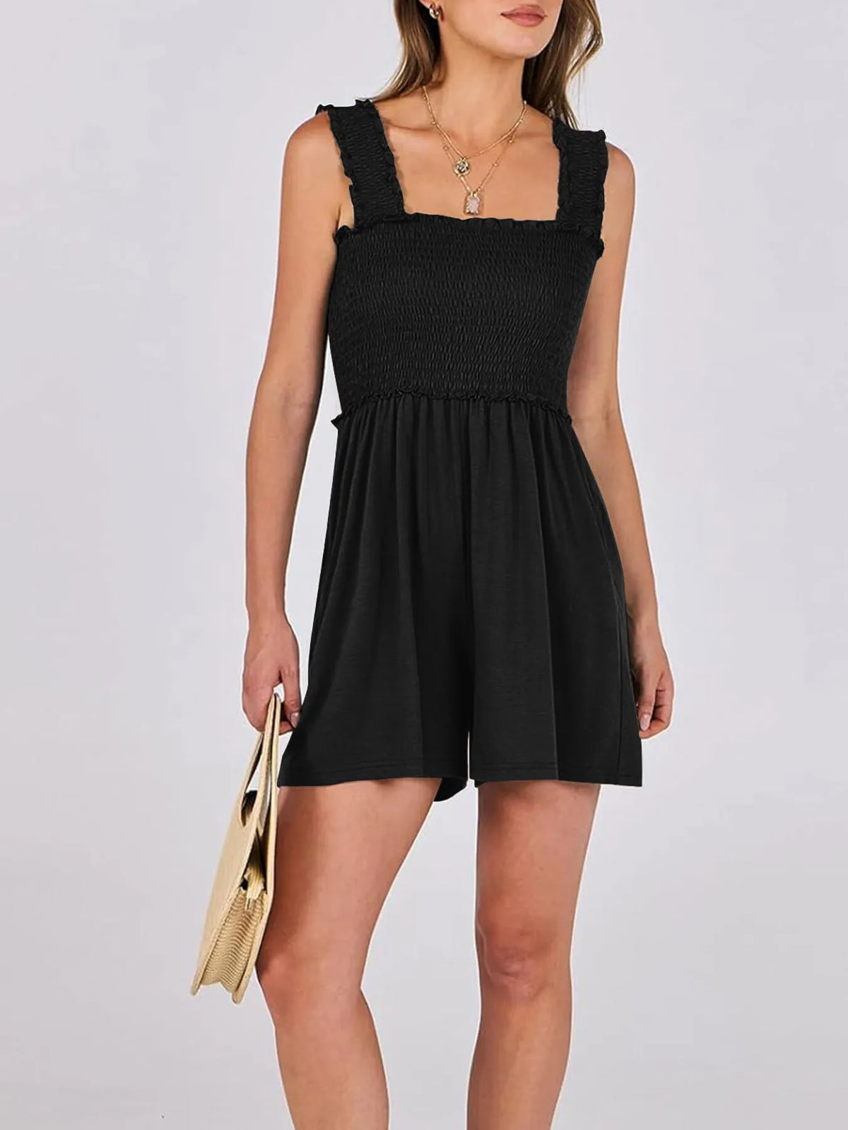 Angled view of Smocked Square Neck Sleeveless Romper in black with pockets – Voguelle