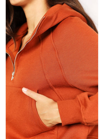 Model smiling in rust cropped half-zip hoodie – Voguelle