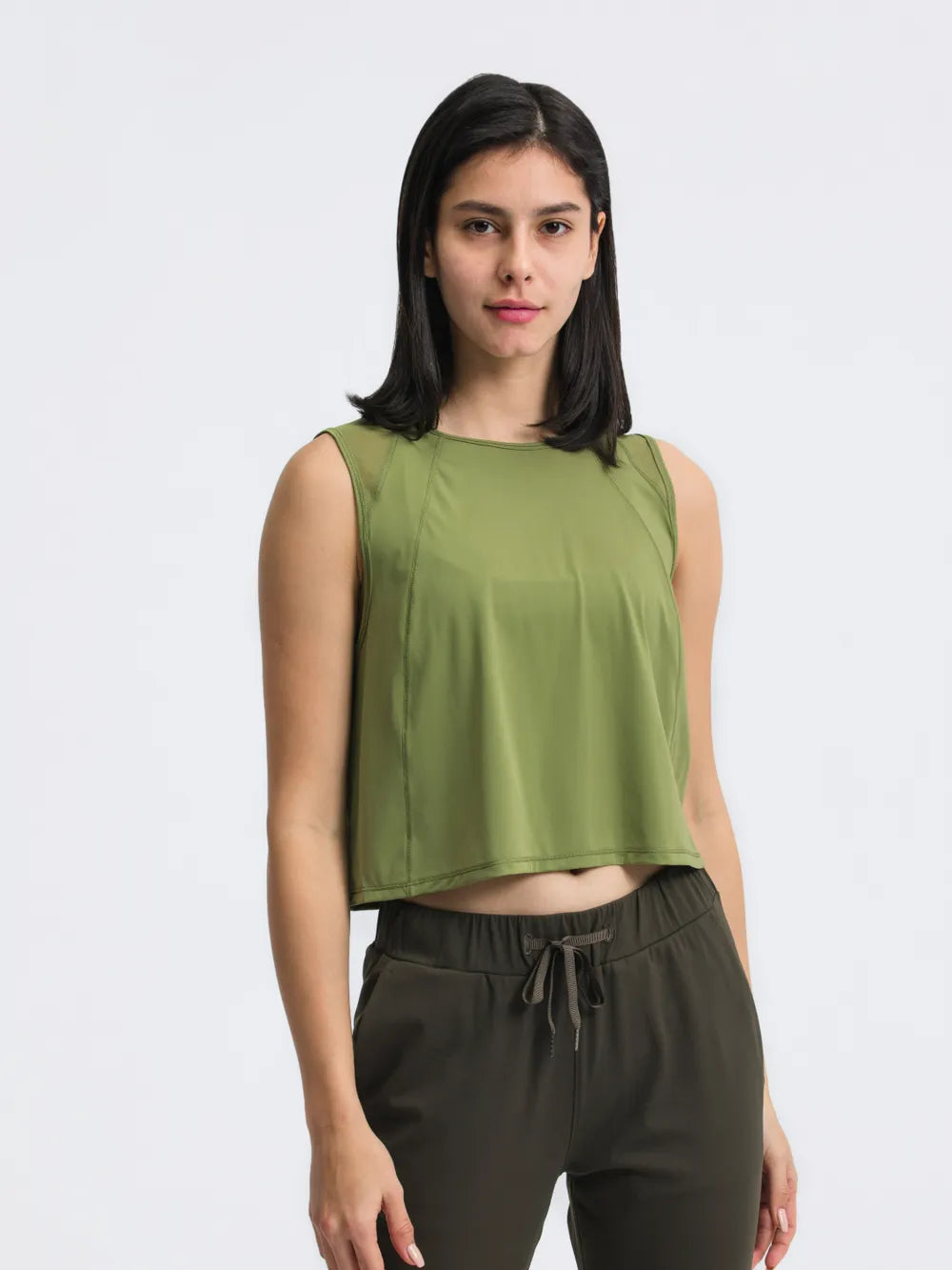 Model wearing Millennia Cropped Active Tank in green – Voguelle