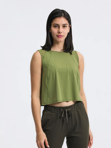 Model wearing Millennia Cropped Active Tank in green – Voguelle