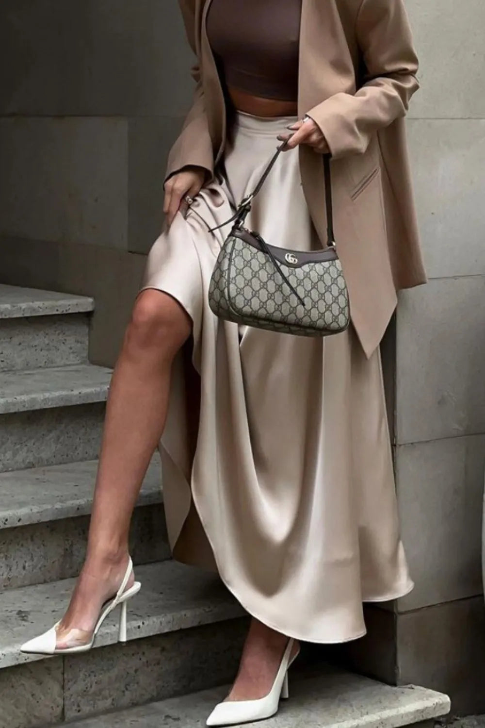 Champagne satin midi skirt styled with blazer, model standing on steps – Voguelle