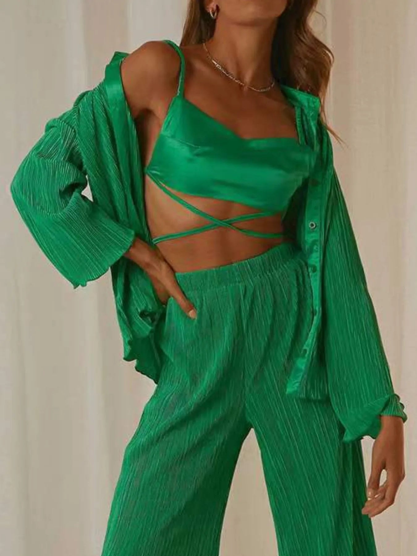 Model posing in vibrant orange two-piece shirt and pants set – Voguelle