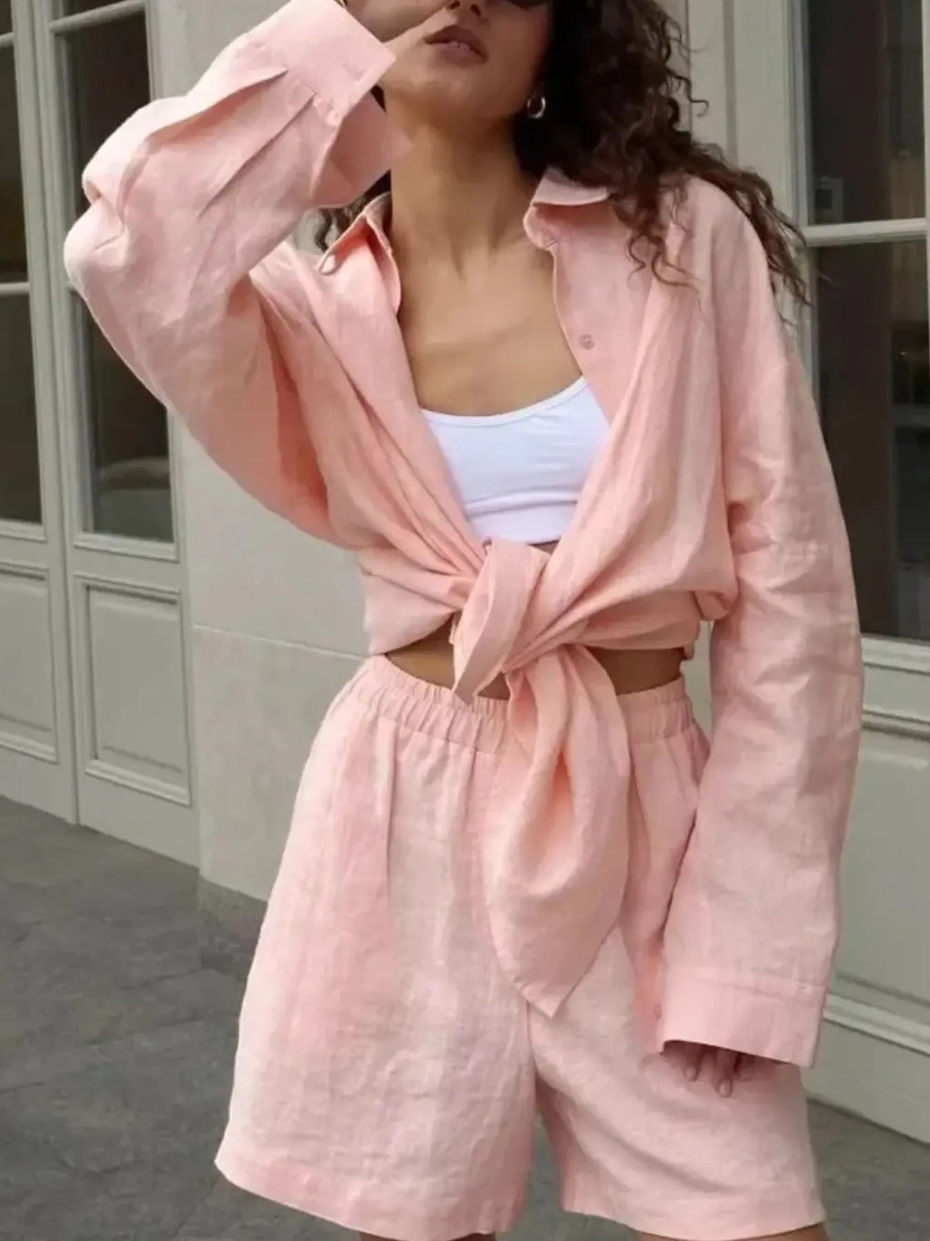Close-up of collar and sleeve detail on pink button-up shirt – Voguelle