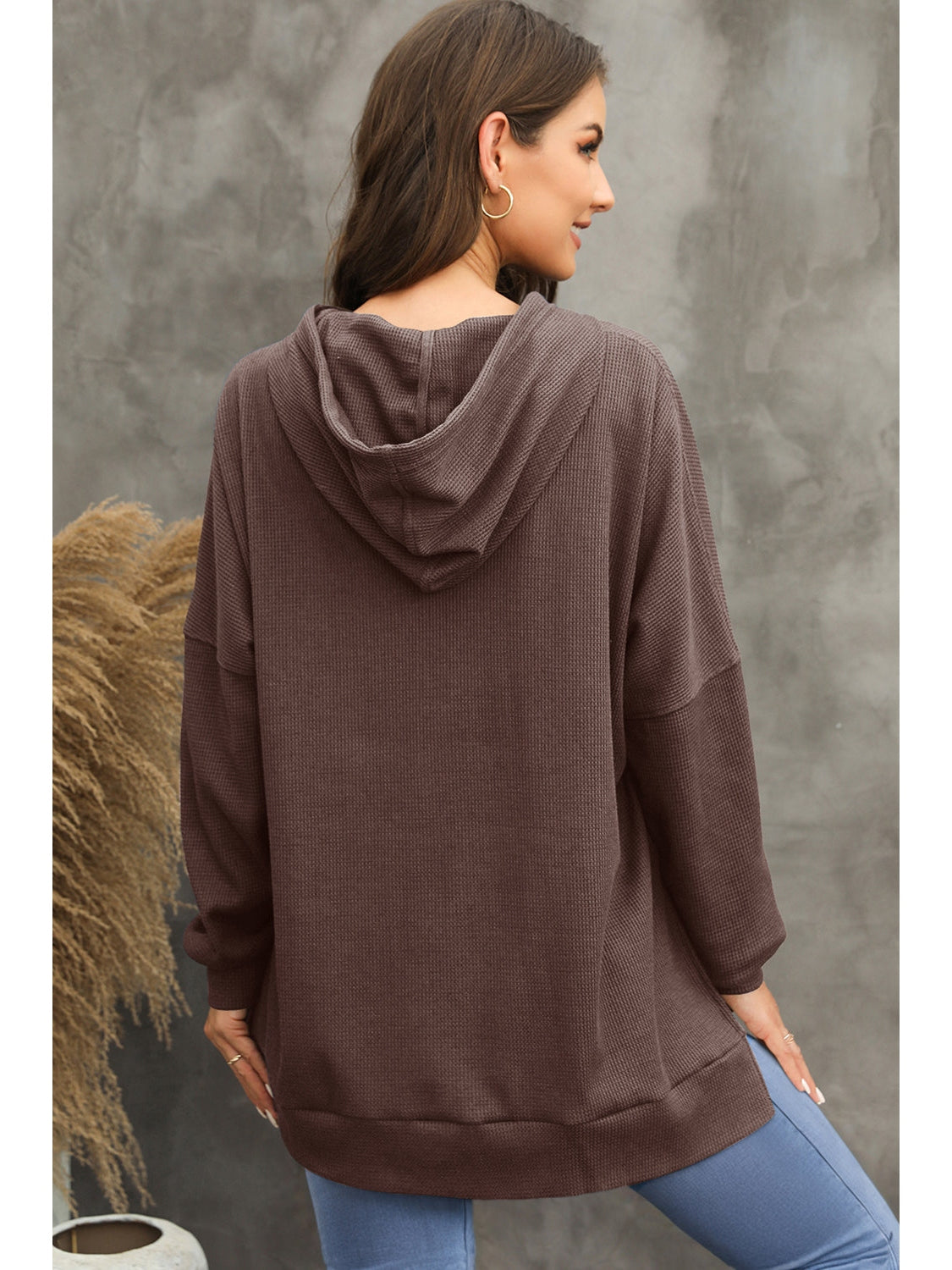 Lifestyle shot of gray waffle-knit hoodie paired with denim jeans – Voguelle