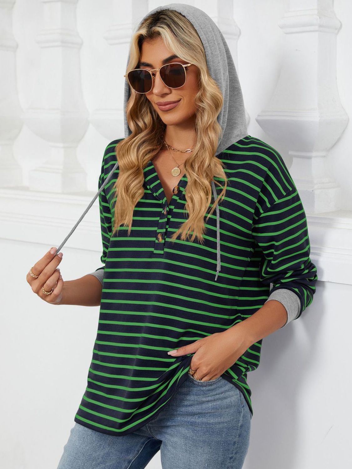 Model wearing striped drawstring hoodie with button detail – Voguelle