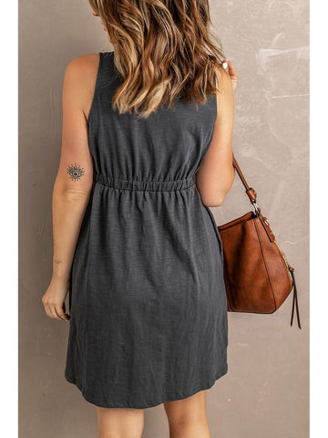 Model holding handbag styled with sleeveless black mini dress – Voguelle