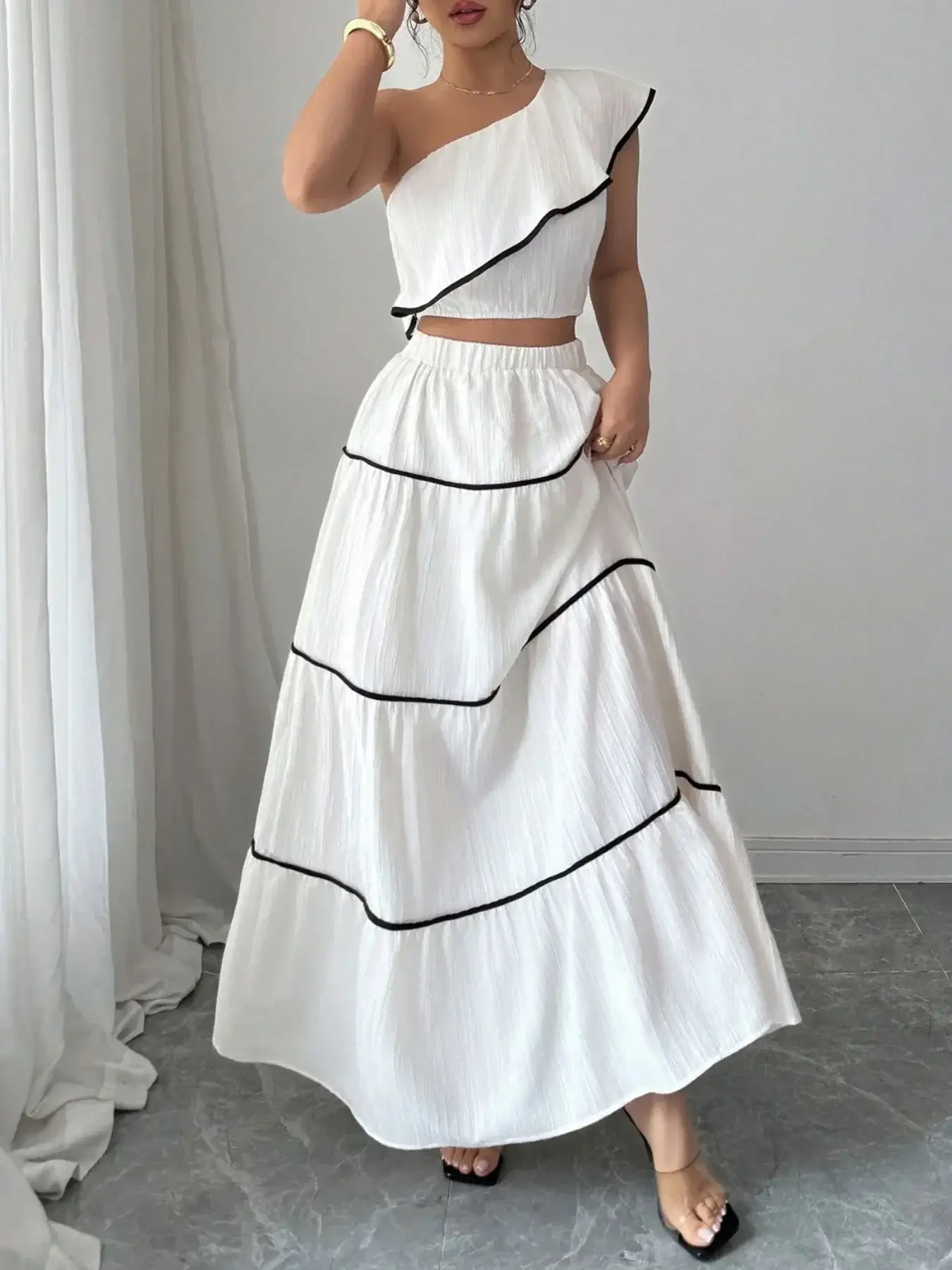 Model wearing chic white one-shoulder ruffle top and skirt set – Voguelle