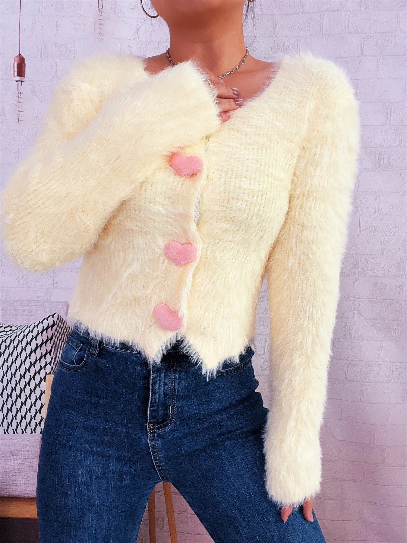 Angled view of yellow fuzzy cardigan with heart button details – Voguelle