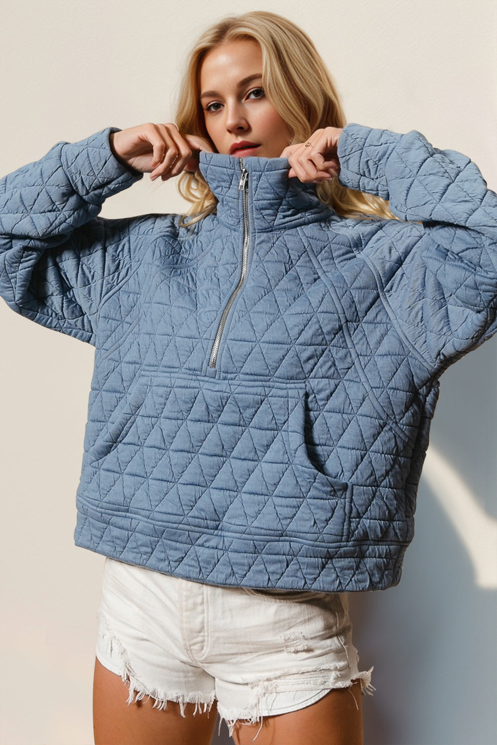 Close-up of quilted texture half zip sweatshirt – Voguelle