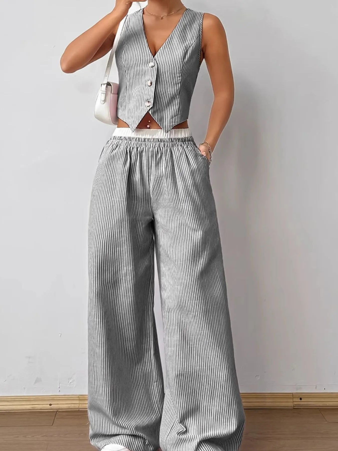 Close-up front detail striped vest and pants outfit – Voguelle