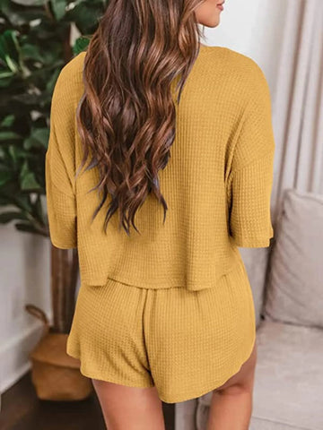 Close-up of textured waffle knit fabric detail in mustard yellow lounge set – Voguelle