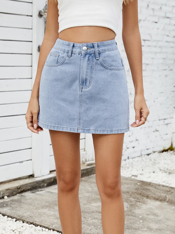 Model wearing solid mini denim skirt with white top, full outfit view – Voguelle