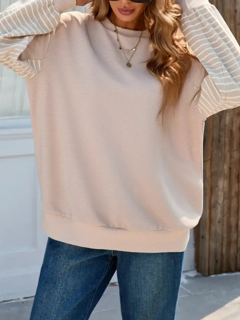 Side angle of Striped Patchwork Long Sleeve Sweatshirt in beige – Voguelle