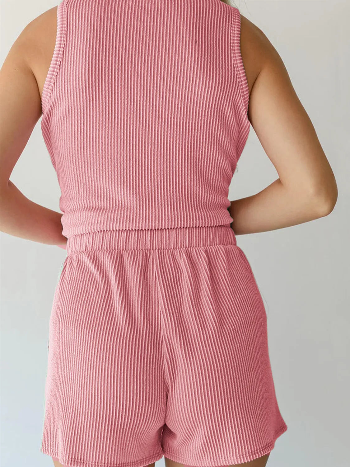 Pink ribbed fabric close-up of women’s two-piece outfit – Voguelle