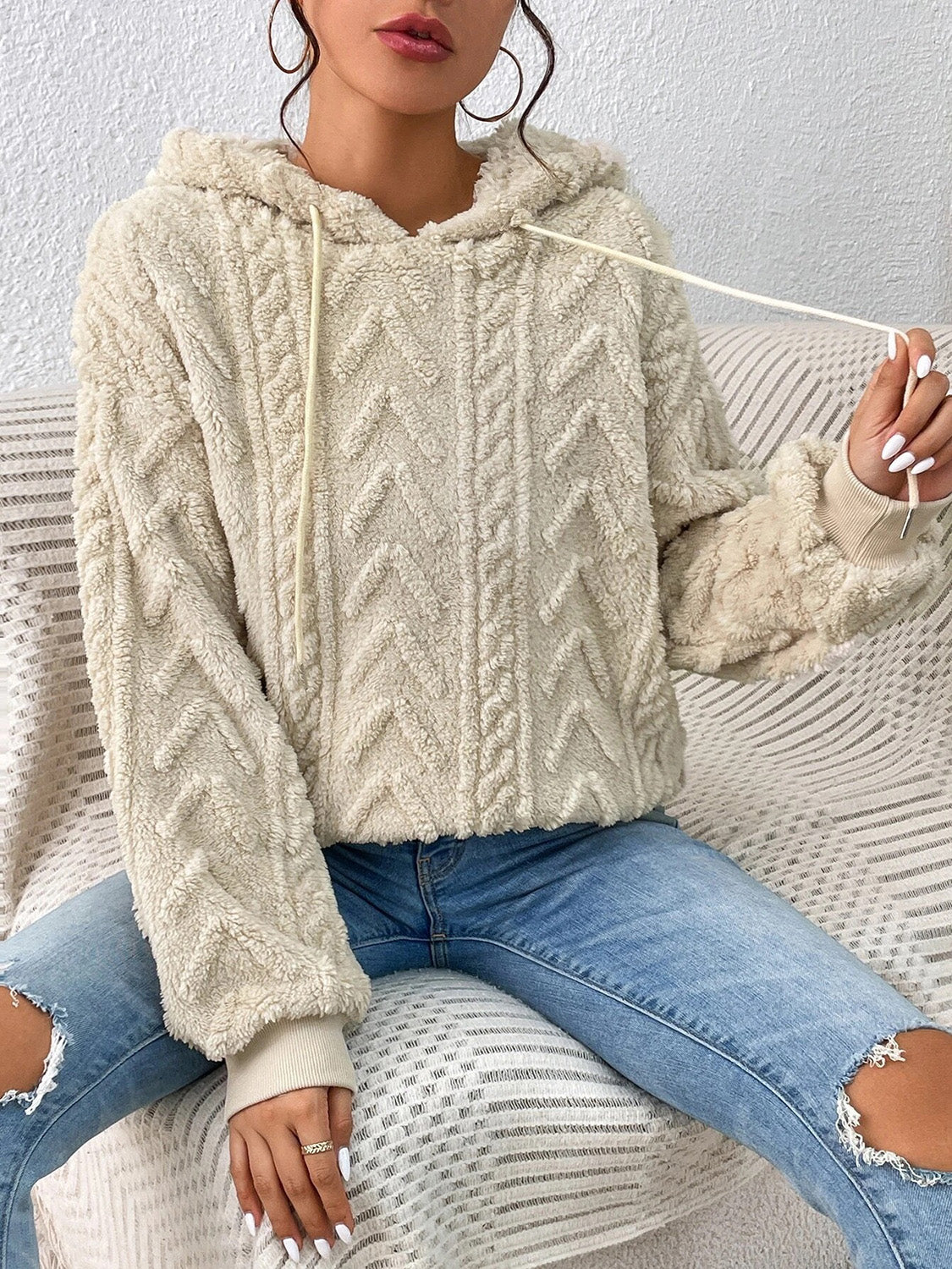 Side profile of model wearing beige fleece drawstring hoodie – Voguelle