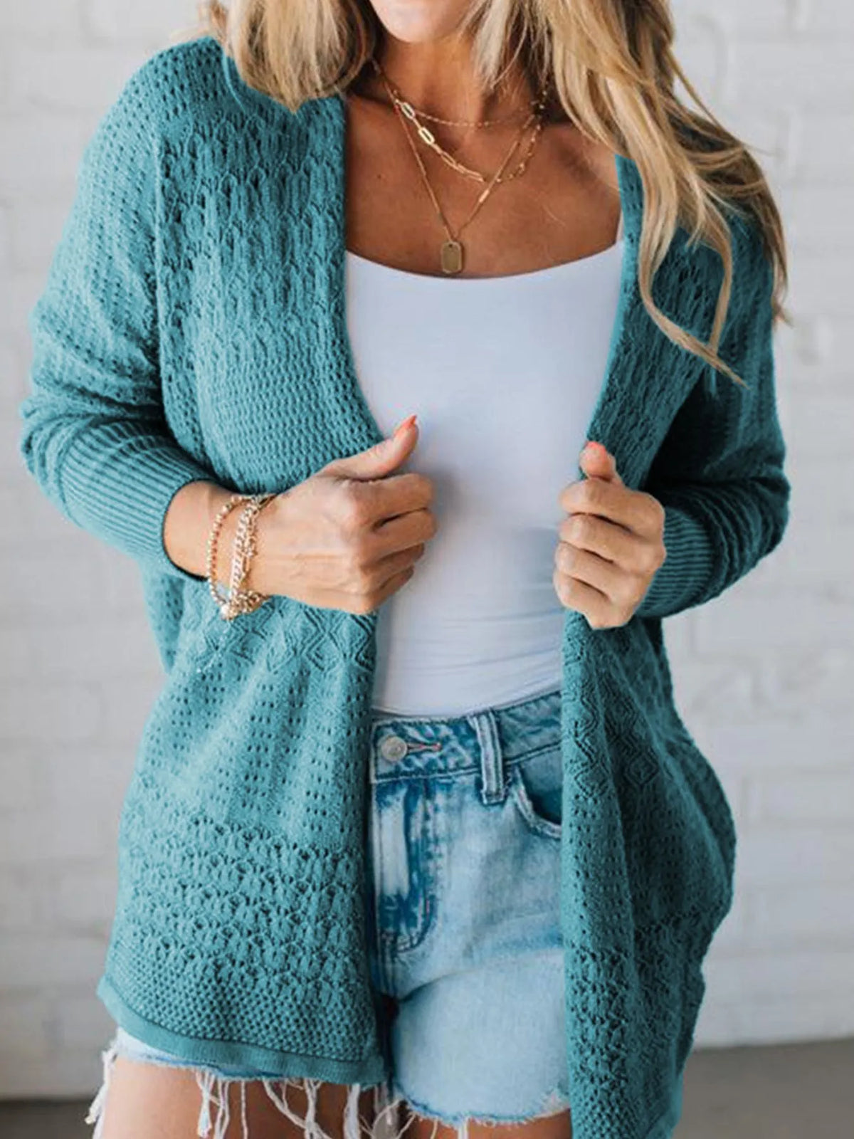 Front styling of teal knitted open front cardigan on model – Voguelle