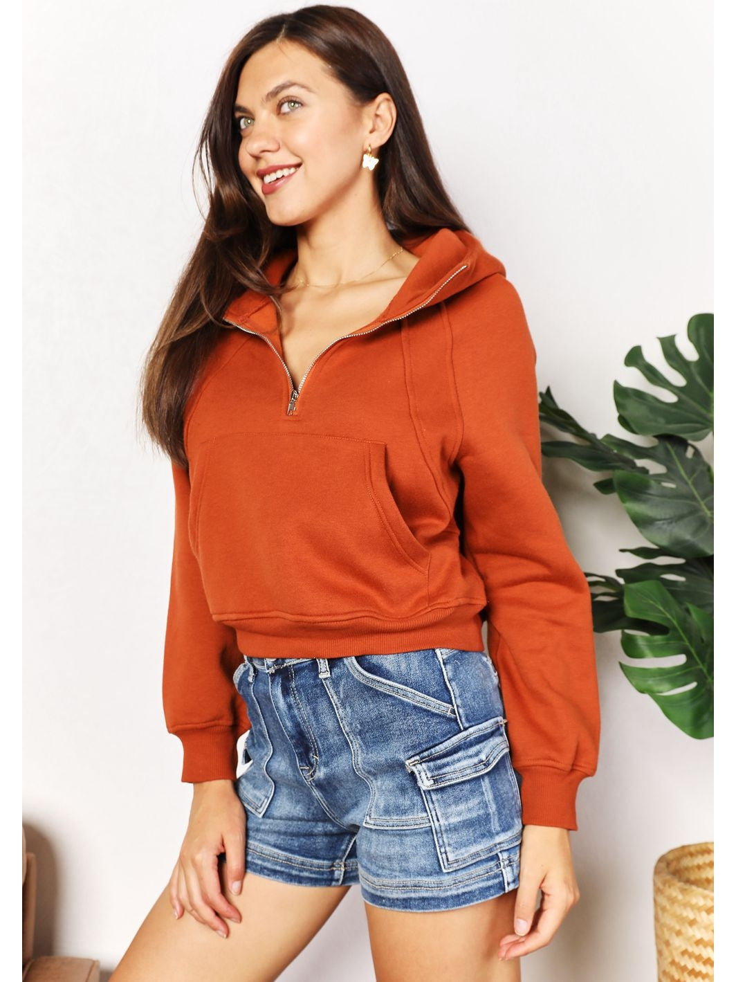 Rust cropped hoodie styled with denim shorts on model – Voguelle