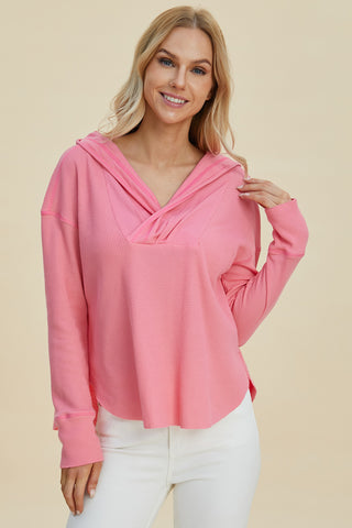 Close-up of womens pink hooded pullover – Voguelle