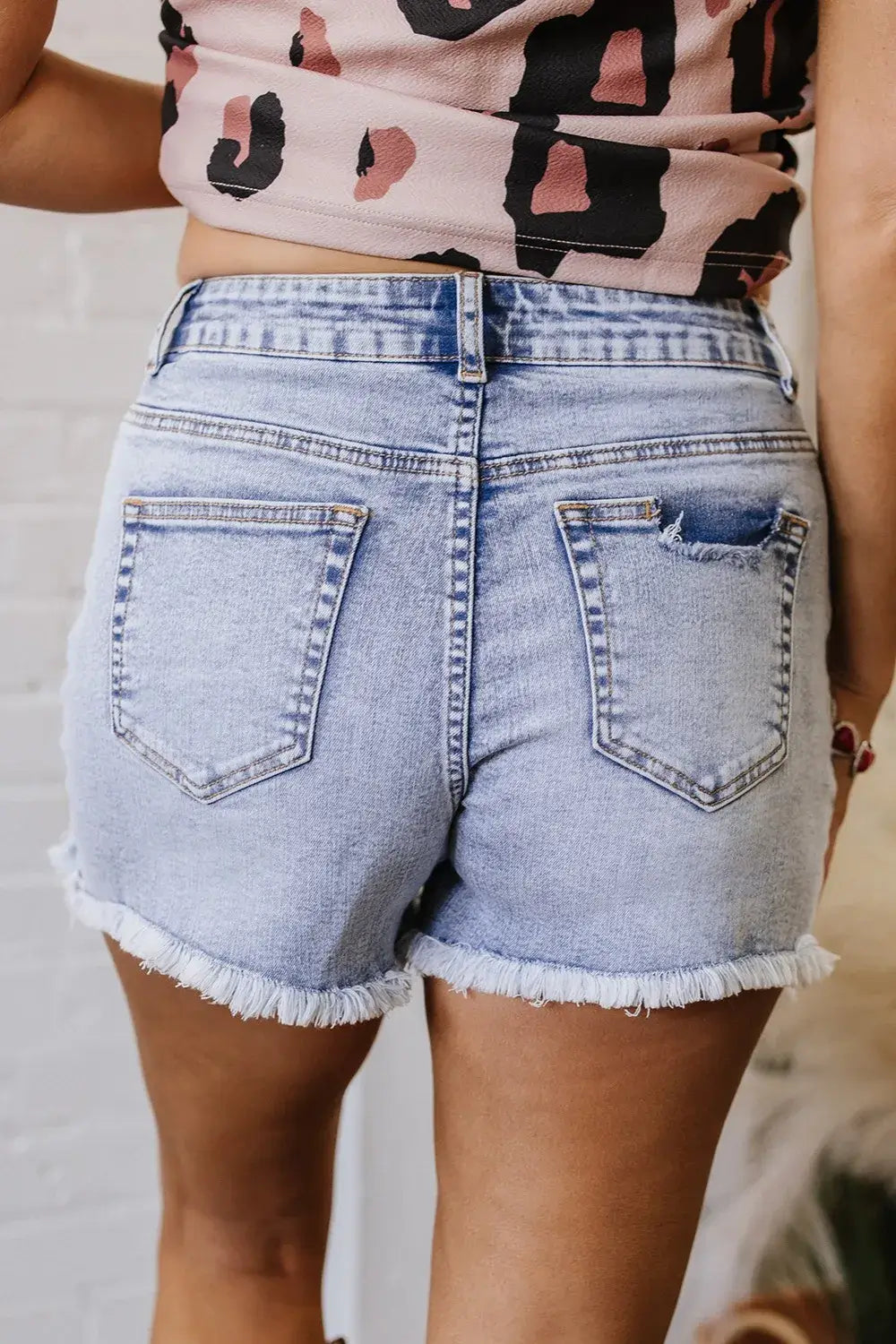 Back view of high-waisted pearl studded denim shorts – Voguelle