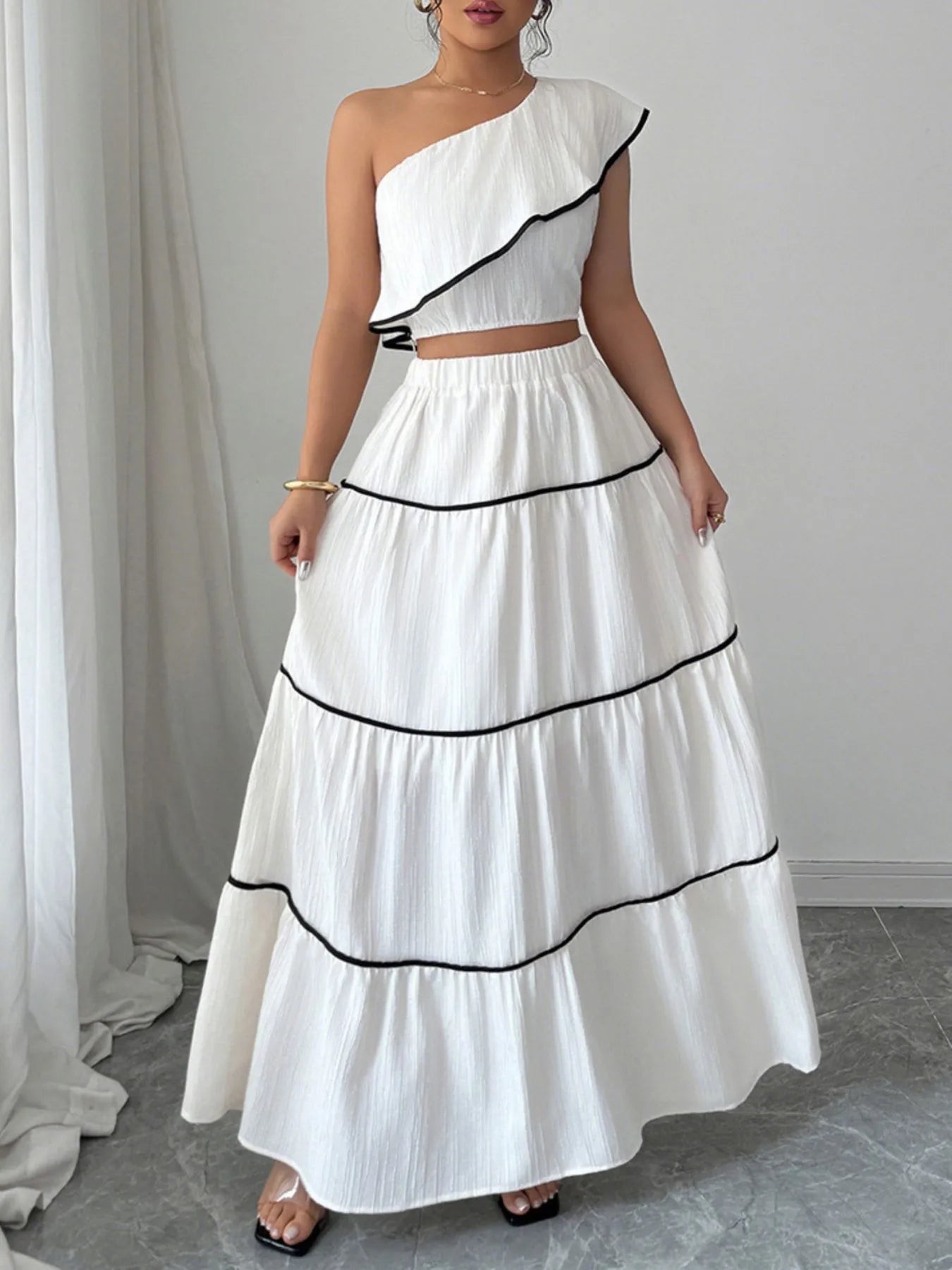 Casual pose of elegant white ruffle crop top with long skirt outfit – Voguelle