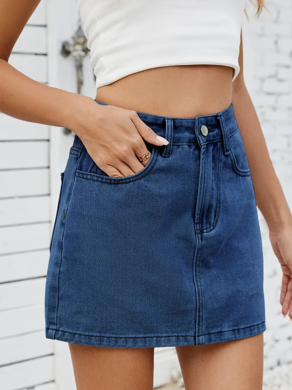 Side view of solid mini denim skirt showing pocket and fit – Voguelle
