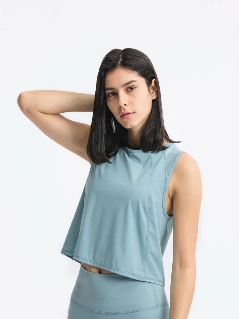 Front view of Millennia Cropped Active Tank in light blue on model – Voguelle