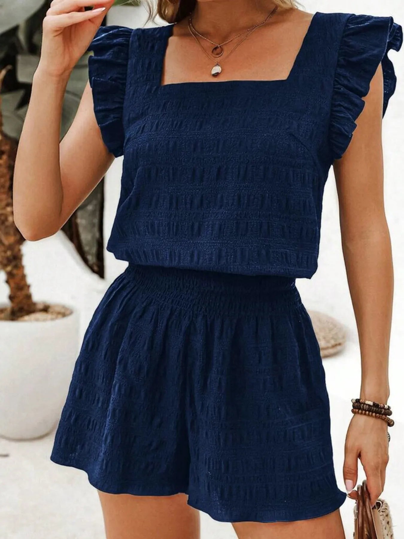 Model showing relaxed fit of navy shirred high waist shorts with crop top – Voguelle
