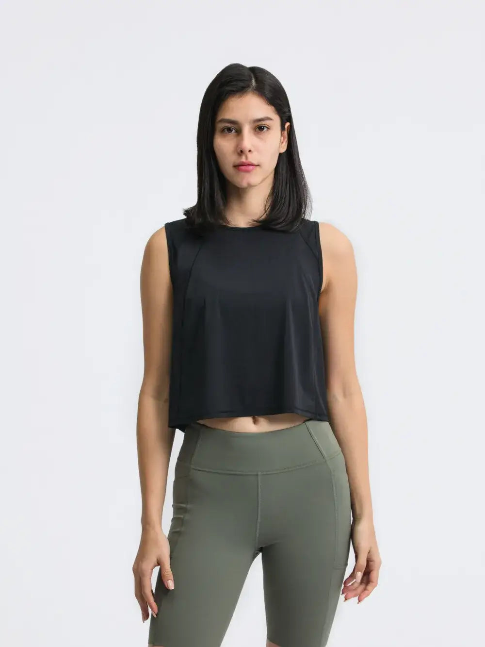 Model posing in Millennia Cropped Active Tank in black – Voguelle