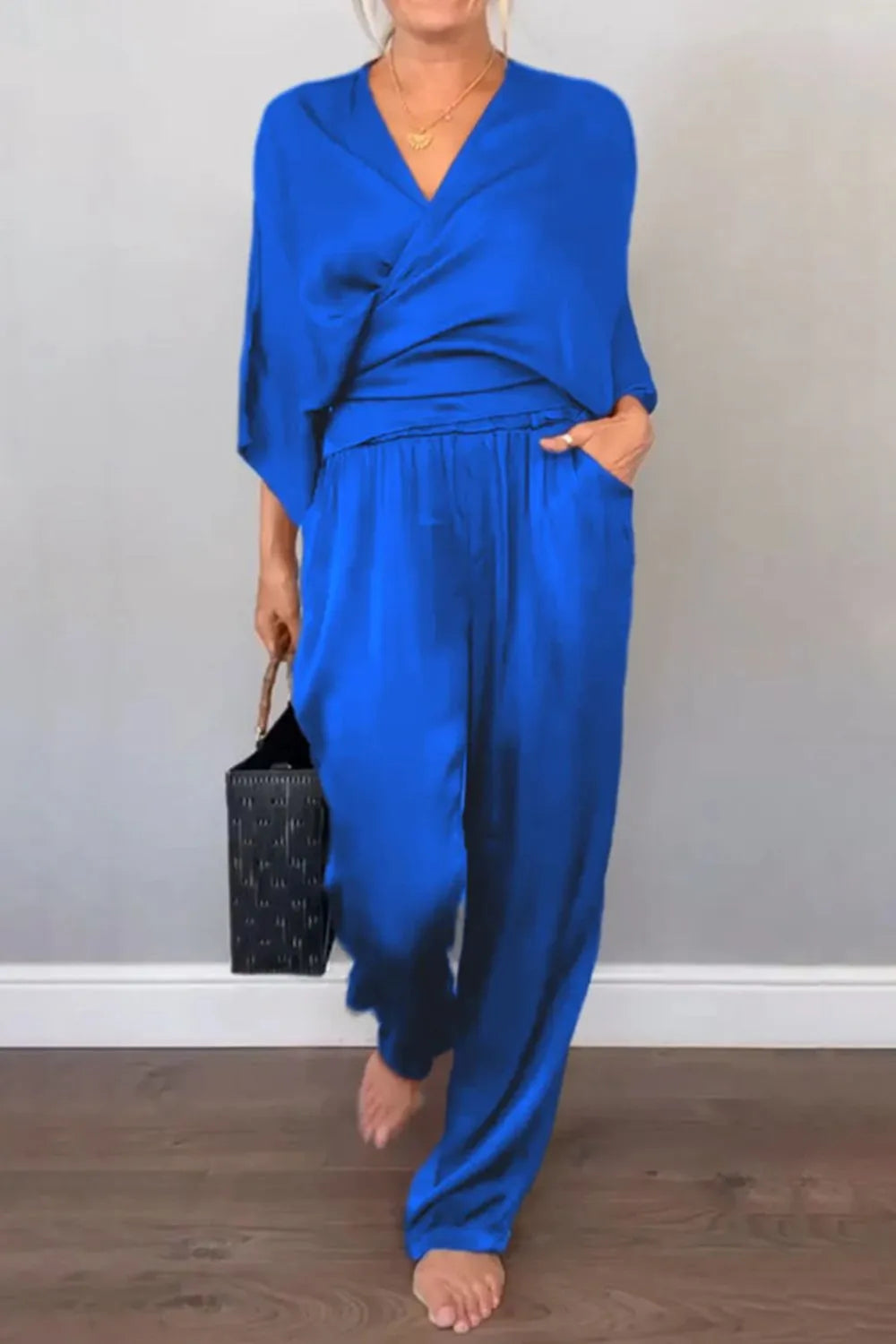 Modern wide-leg black jumpsuit with draped neckline – Voguelle