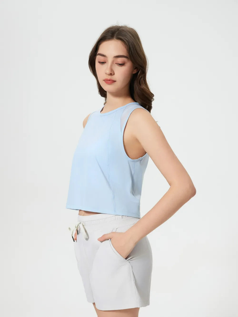 Side angle of Millennia Cropped Active Tank in beige – Voguelle