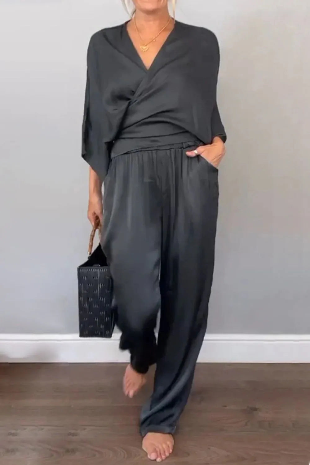 Full-length wide-leg jumpsuit with wrap neckline in black – Voguelle