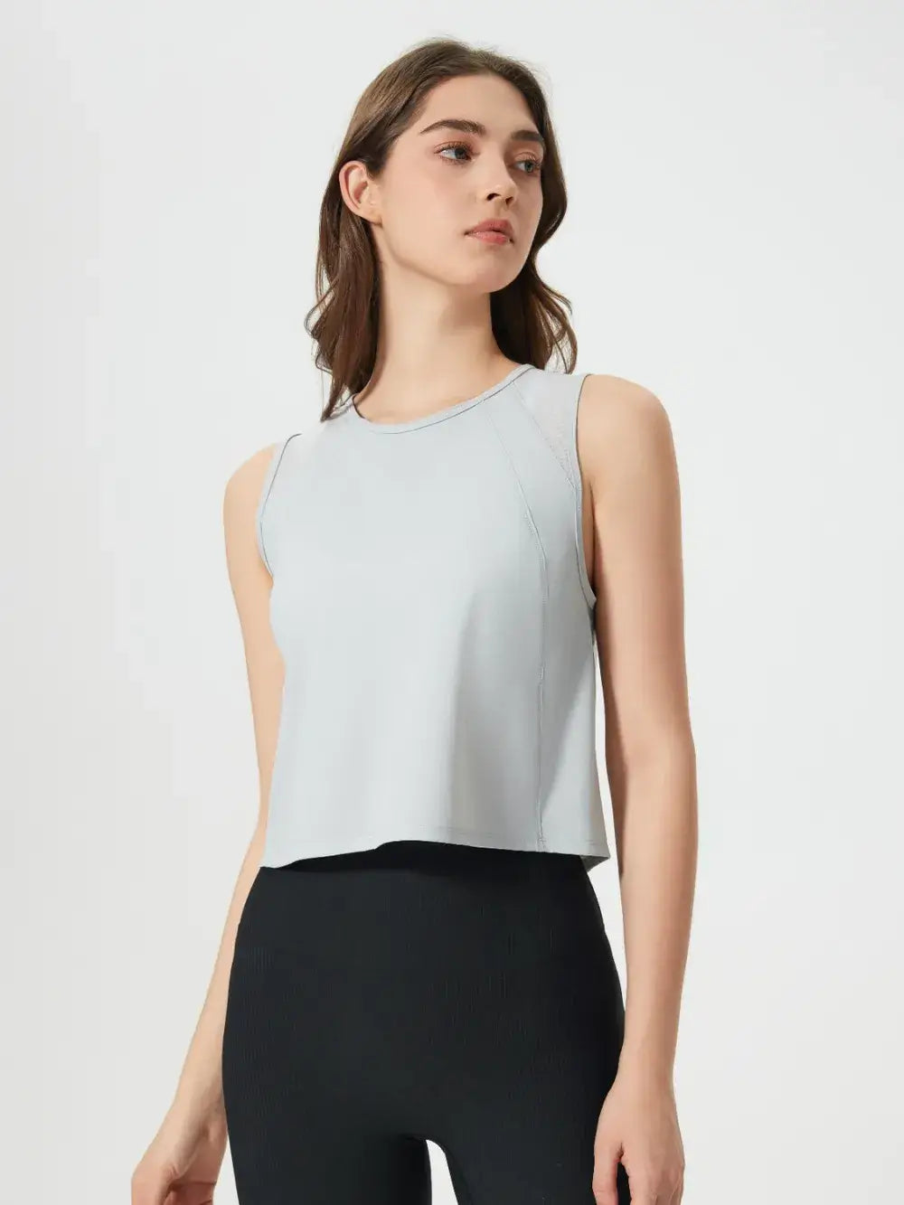 Front view of Millennia Cropped Active Tank in white on model – Voguelle