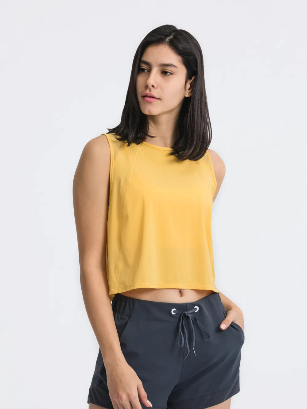 Front view of Millennia Cropped Active Tank in yellow on model – Voguelle