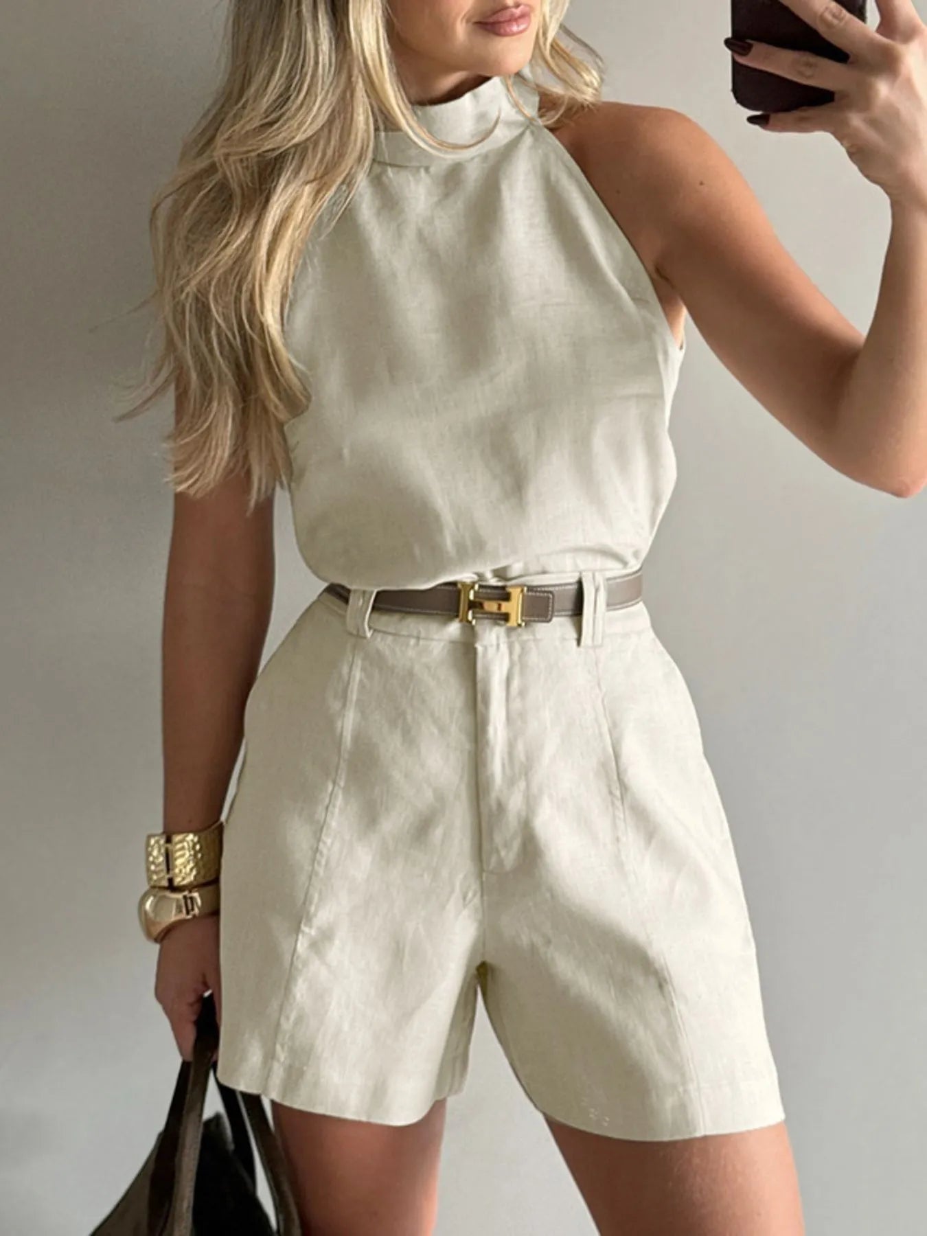 Close-up of beige linen halter neck top tucked into high-waist shorts – Voguelle