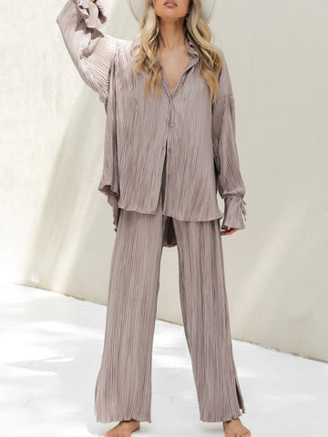 Black pleated co-ord outfit styled with strappy sandals – Voguelle
