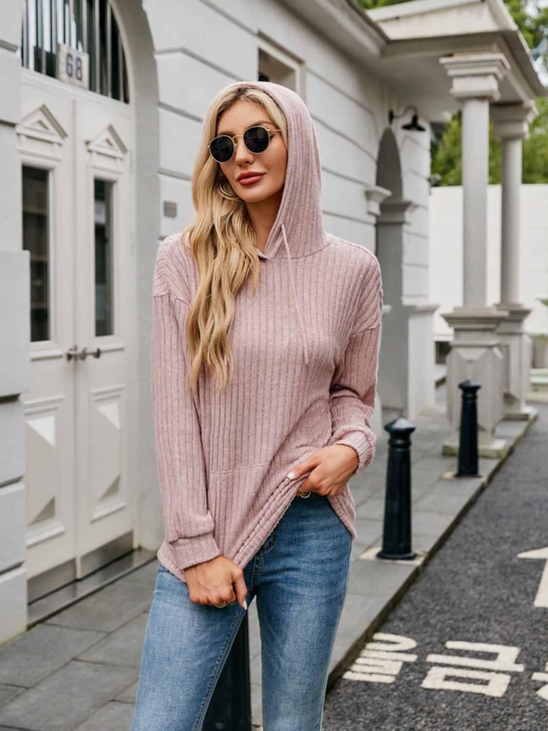 Beige ribbed hoodie with front pocket detail on model – Voguelle