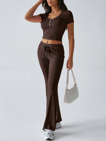 Model holding white handbag with pink ribbed lounge set – Voguelle