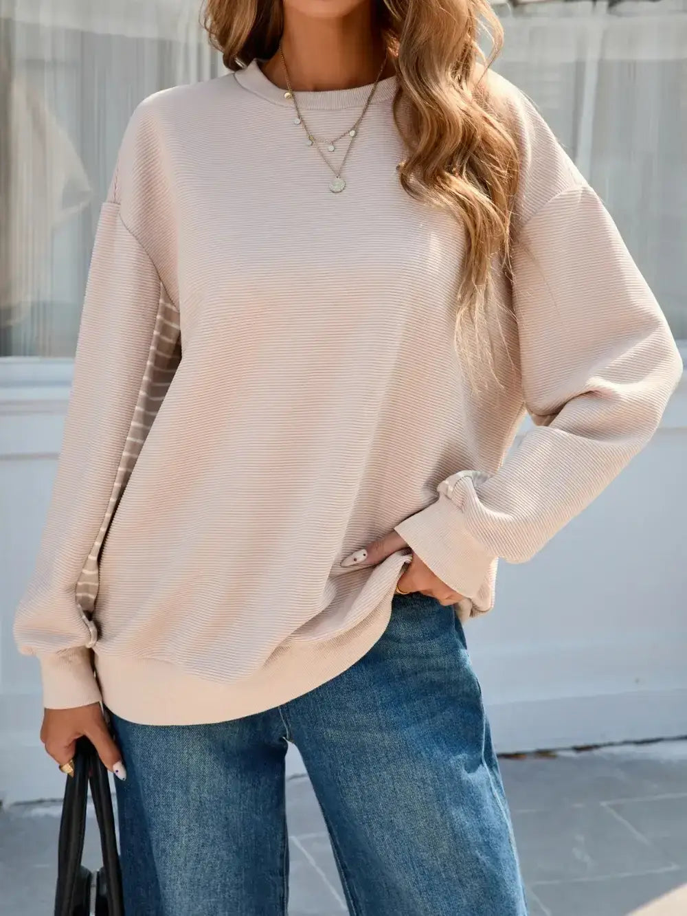 Front view of Striped Patchwork Long Sleeve Sweatshirt in beige on model – Voguelle