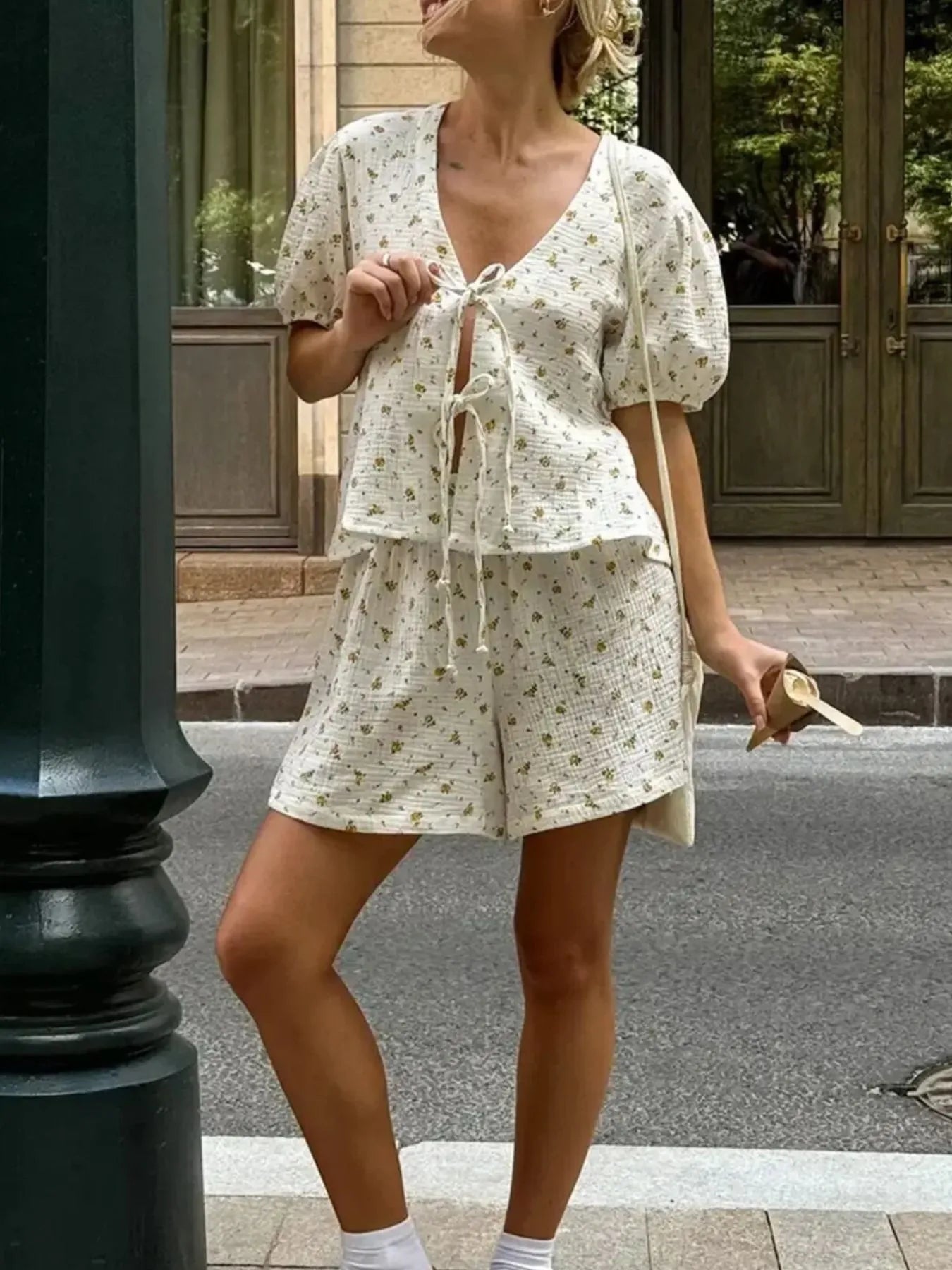 Front view of floral print tie-front crop top and shorts set in white – Voguelle