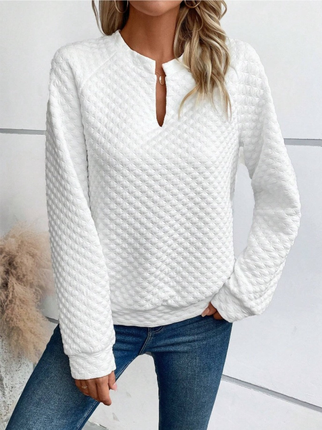 Close-up of quilted texture notched neck sweatshirt – Voguelle