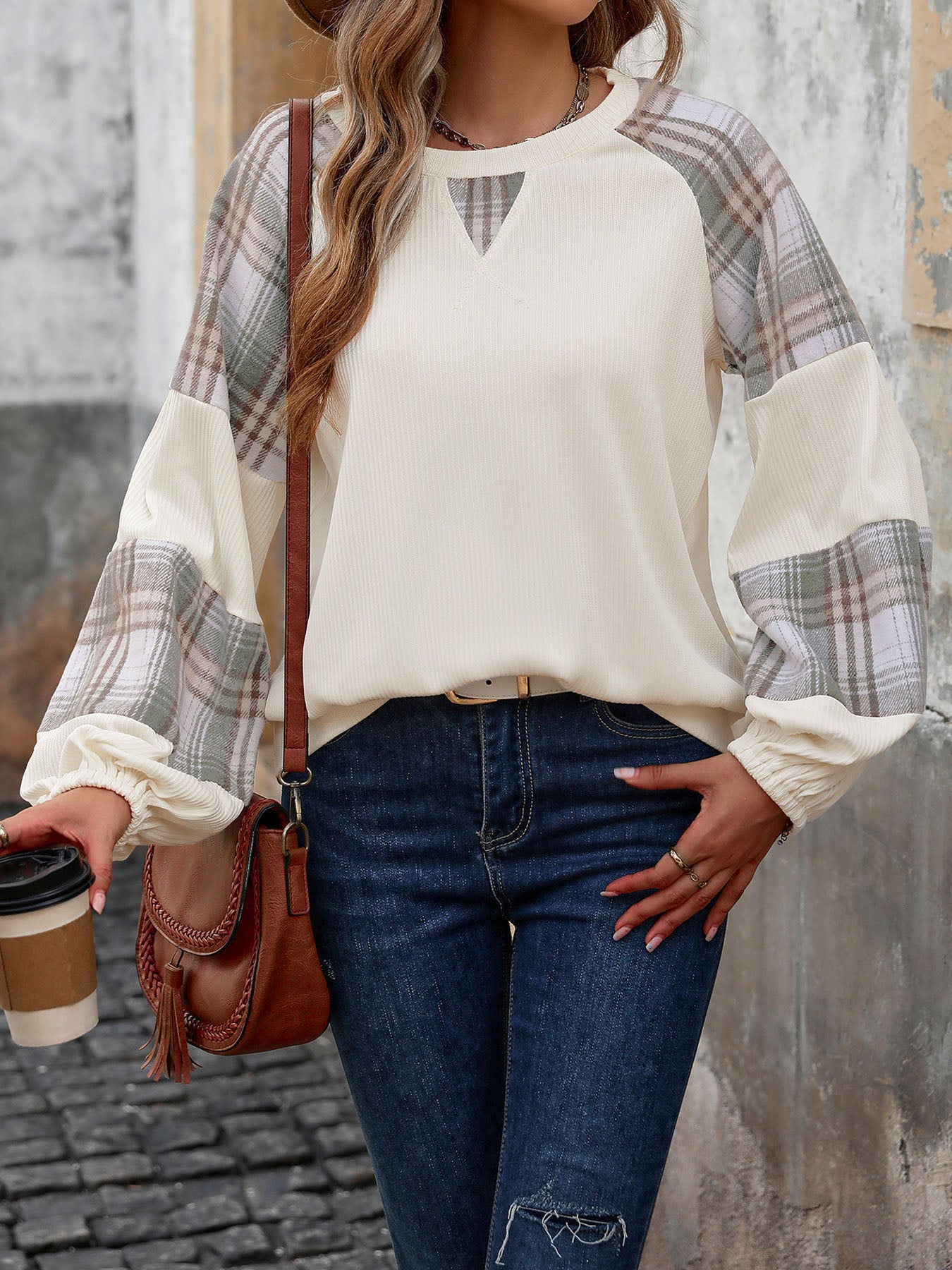 Model wearing cream sweatshirt with plaid sleeves – Voguelle