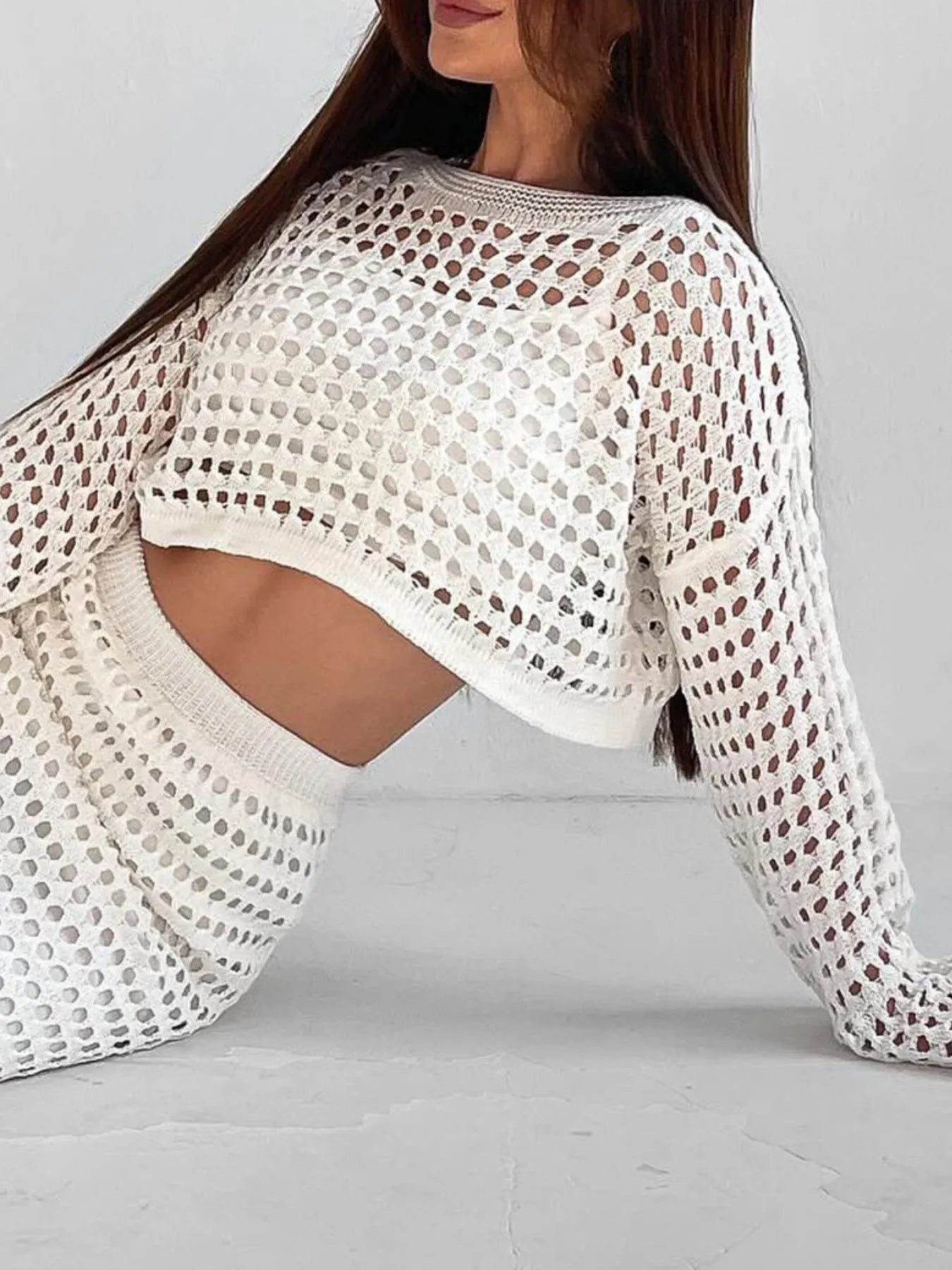 Close-up of hollow out knit crop top with round neck in white – Voguelle