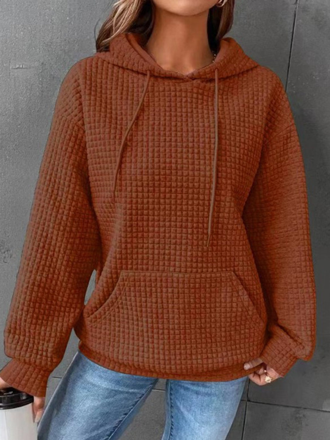 Model holding cup wearing beige textured hoodie – Voguelle