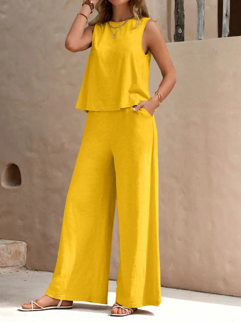 Model wearing beige wide leg pants with sleeveless top – Voguelle